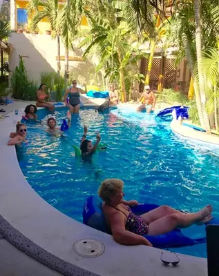 a group of people in the swimming pool at a resort at Ten North Tamarindo Beach Hotel in Tamarindo