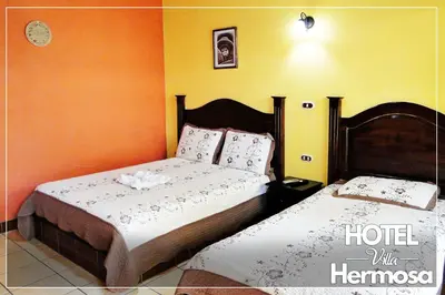 a bedroom with two beds in a room at Hotel Villa Hermosa in Liberia