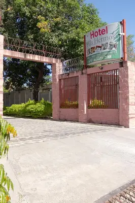 an entrance to a hotel with a gate and a sign at Hotel Villa Hermosa in Liberia