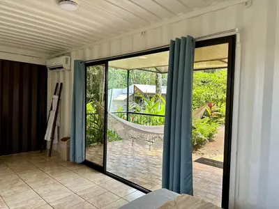 a room with sliding glass doors with a view of a yard at Almendros Eco-Villas in Fortuna