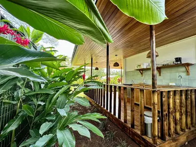 an outdoor kitchen in a garden with plants at Almendros Eco-Villas in Fortuna