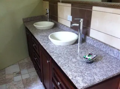 a bathroom counter with a sink and a mirror at Casa Playa Bahia Ballena de Osa in Uvita