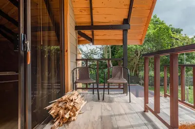 two chairs on the porch of a house at Hotel & Spa Escondite de la Montaña in Sabana Redonda