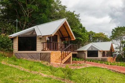 a house with a metal roof on top of a yard at Hotel & Spa Escondite de la Montaña in Sabana Redonda
