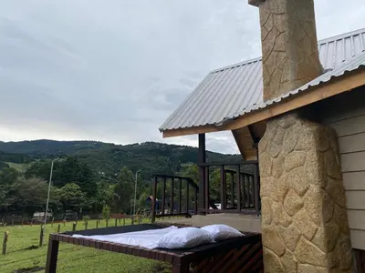a bed on the back of a house at Hotel & Spa Escondite de la Montaña in Sabana Redonda