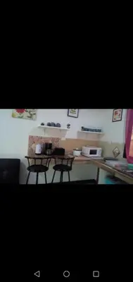 a kitchen with two chairs and a table in a room at Villa De Los Monos, casitas equipadas en Guanacaste in Matapalo