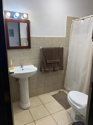 a bathroom with a sink and a toilet and a mirror at Cocomarindo Condo #72 in Coco
