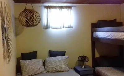 a bedroom with two bunk beds and a window at Montaña Linda Guest House Orosi in Orosí