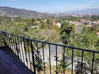 a balcony with a view of a city at Hotel Monte Campana Escazu in San José