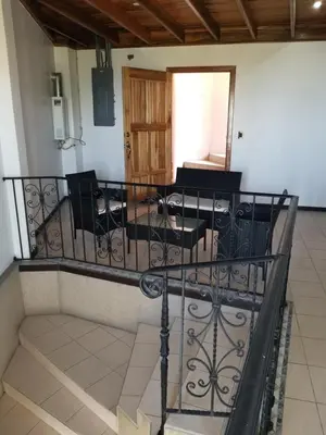 a room with a balcony with a table and chairs at Hotel Monte Campana Escazu in San José