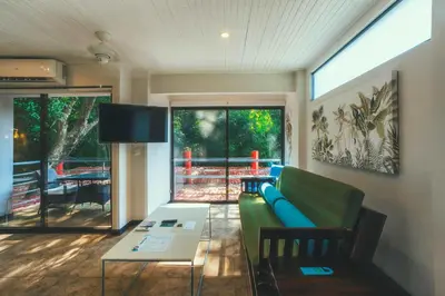 a living room with a green couch and a table at Jungle Vista Boutique Hotel in Manuel Antonio