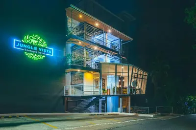 a building with a sign on the side of it at Jungle Vista Boutique Hotel in Manuel Antonio