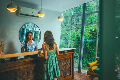 a young girl standing in front of a mirror at Jungle Vista Boutique Hotel in Manuel Antonio