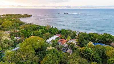 an aerial view of a house next to the ocean at The Coast Beachfront Hotel in Tamarindo