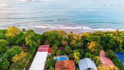 an aerial view of a resort by the ocean at The Coast Beachfront Hotel in Tamarindo
