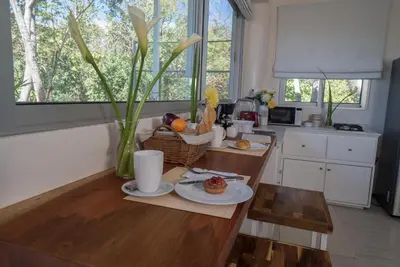 a kitchen with a table with a basket of food on it at Moana Surf Resort in Nosara