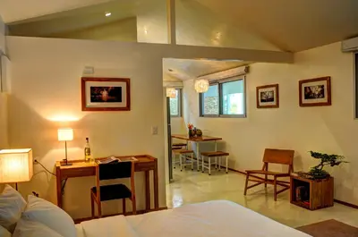 a living room with a bed and a table and chairs at Moana Surf Resort in Nosara