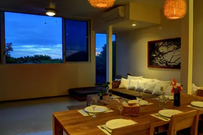 a living room with a table and a couch at Moana Surf Resort in Nosara