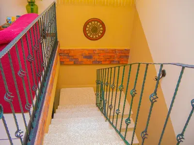 a staircase in a room with a stair railing at Hotel Bamboo Aeropuerto in Alajuela City