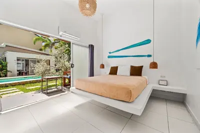 a bedroom with a bed and a pool at La Ramona Charming Hotel in Tamarindo