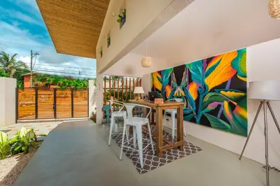 a dining room with a colorful painting on the wall at La Ramona Charming Hotel in Tamarindo