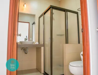 a bathroom with a shower and a toilet and a sink at Hotel Terra Viva in Quesada