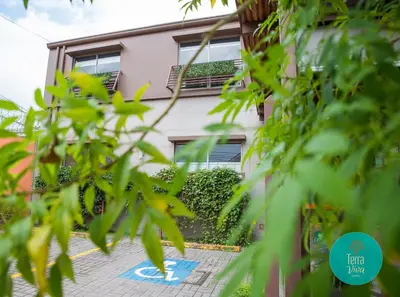 a house seen through the leaves of trees at Hotel Terra Viva in Quesada