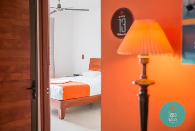 a bedroom with a bed and a floor lamp at Hotel Terra Viva in Quesada