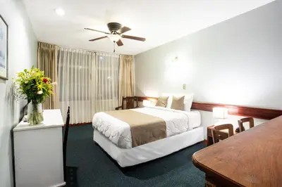 a hotel room with a bed and a table at Apartotel Tairona in San Pedro