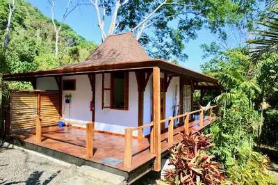 a gazebo with a deck in a garden at Uvita Bali Bosque Retreat in Uvita