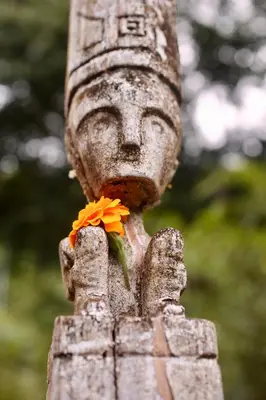 a statue with a flower in its hand at Uvita Bali Bosque Retreat in Uvita