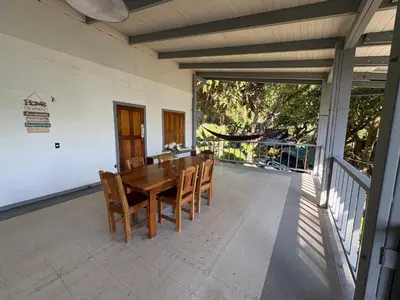 a wooden table and chairs on a patio at Casa Susen in Montezuma