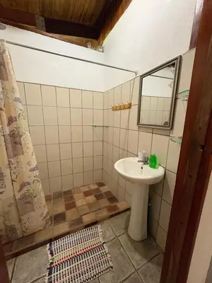 a bathroom with a sink and a mirror at Casa Susen in Montezuma