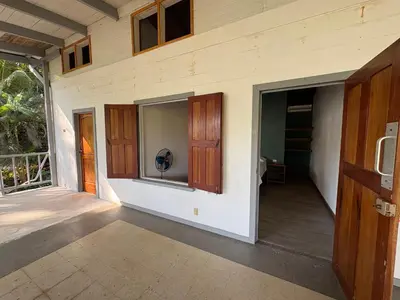 a porch of a house with a door and a window at Casa Susen in Montezuma