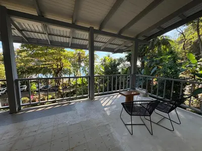 a screened porch with two chairs and a table at Casa Susen in Montezuma