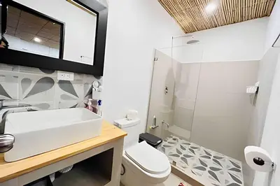 a bathroom with a sink and a toilet at Nirvana Beach Home in Paraíso
