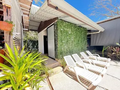 a group of white chairs sitting on a patio at Nirvana Beach Home in Paraíso