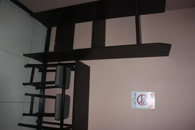 a black bunk bed with a sign on a wall at Hotel Pecos Bill in San José