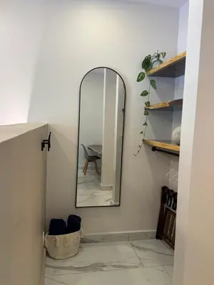 a mirror on a wall in a room with a table at Tamarindo Sunshine in Tamarindo