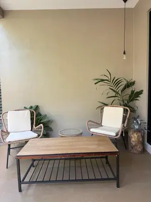 two chairs and a coffee table in a living room at Tamarindo Sunshine in Tamarindo