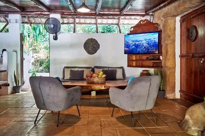 a dining room with a table and two chairs at Havana Lodge in Mal País