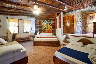 a bedroom with two beds in a room at Havana Lodge in Mal País