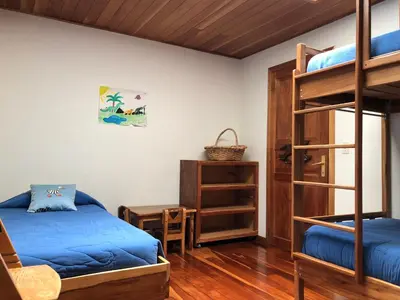 a bedroom with a bunk bed and a desk at Casa Cañitas in Monteverde Costa Rica