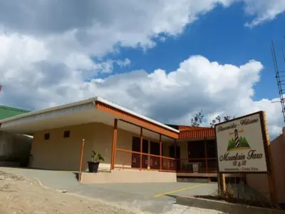 a building with a sign in front of it at Mountain Faro Hotel in Monteverde Costa Rica