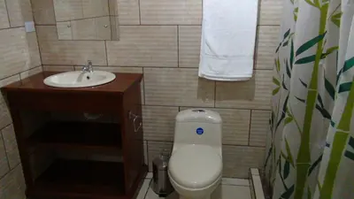 a small bathroom with a toilet and a sink at Mountain Faro Hotel in Monteverde Costa Rica