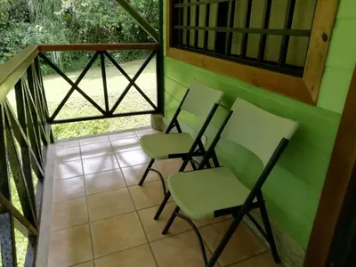 a room with three chairs on a balcony at La Selva Biological Station in Sarapiquí