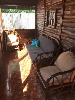 a room with a couch and chairs in a cabin at Hotel Cabañas La Teca in Liberia