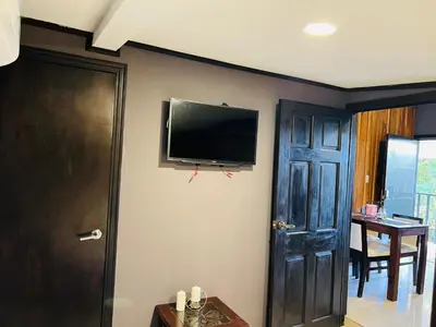 a room with a flat screen tv on a wall at Don Jarvey I Bed & Breakfast in Monteverde Costa Rica