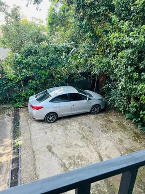 a silver car parked next to a hedge at Don Jarvey I Bed & Breakfast in Monteverde Costa Rica