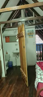 a bathroom with a sink and a toilet in a room at Congos Hostal y Camping in Playa Hermosa